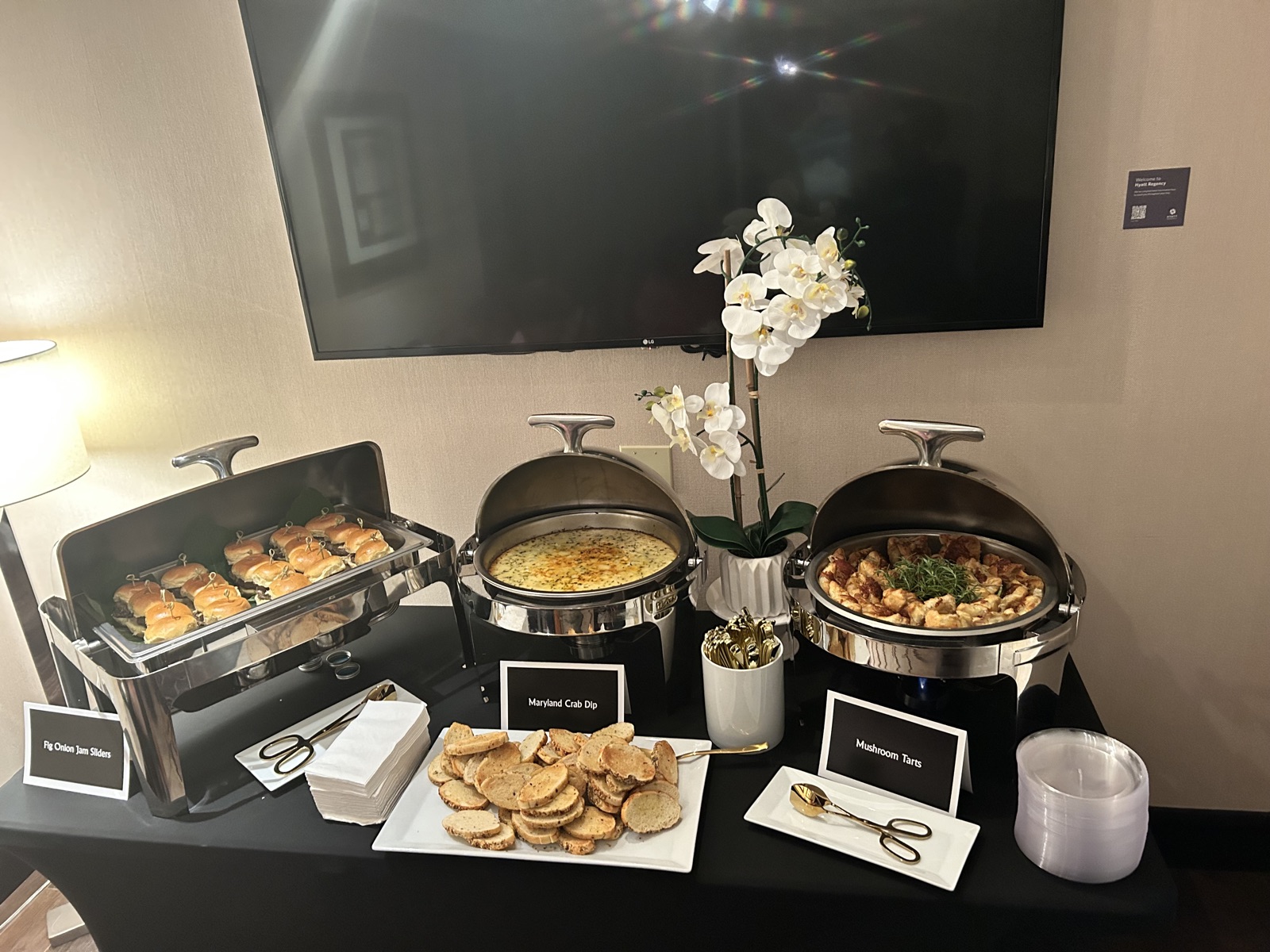 Elegant buffet spread with sliders, crab dip, and mushroom tarts